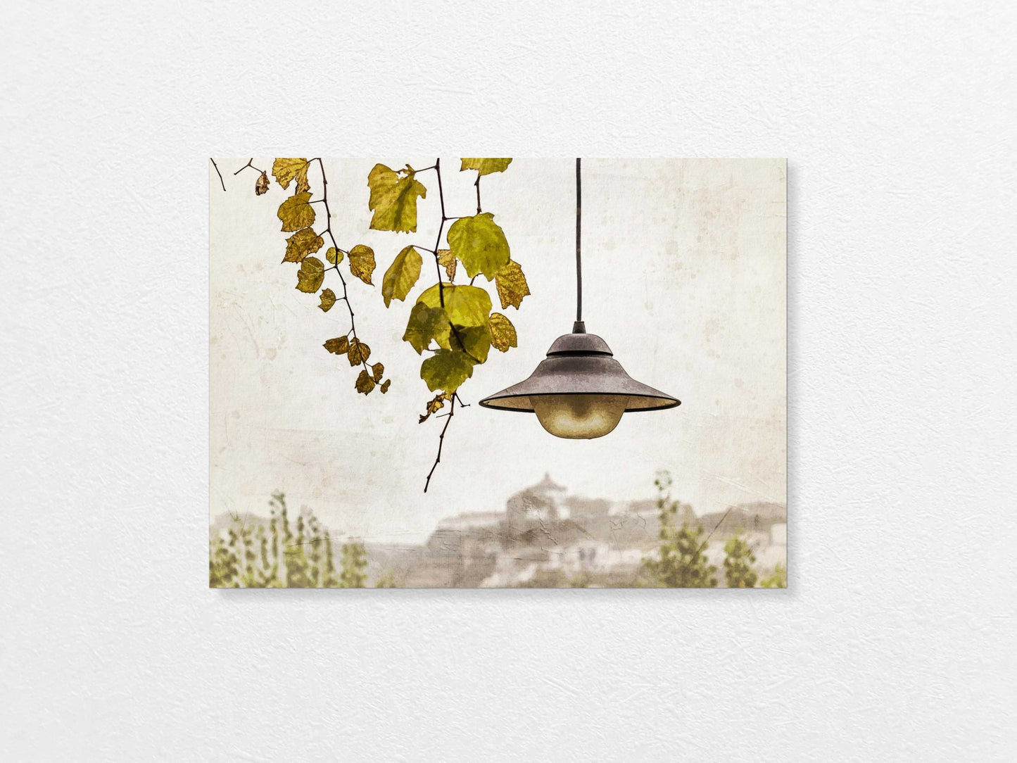 Light bulb hanging above with a view of Porto in the background, featuring trees and buildings.