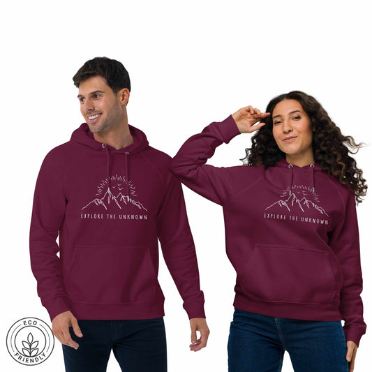Two outdoorsy, man and woman wearing maroon hoodies with a mountain, sun and birds design and 'Explore the Unknown' text on a white background.