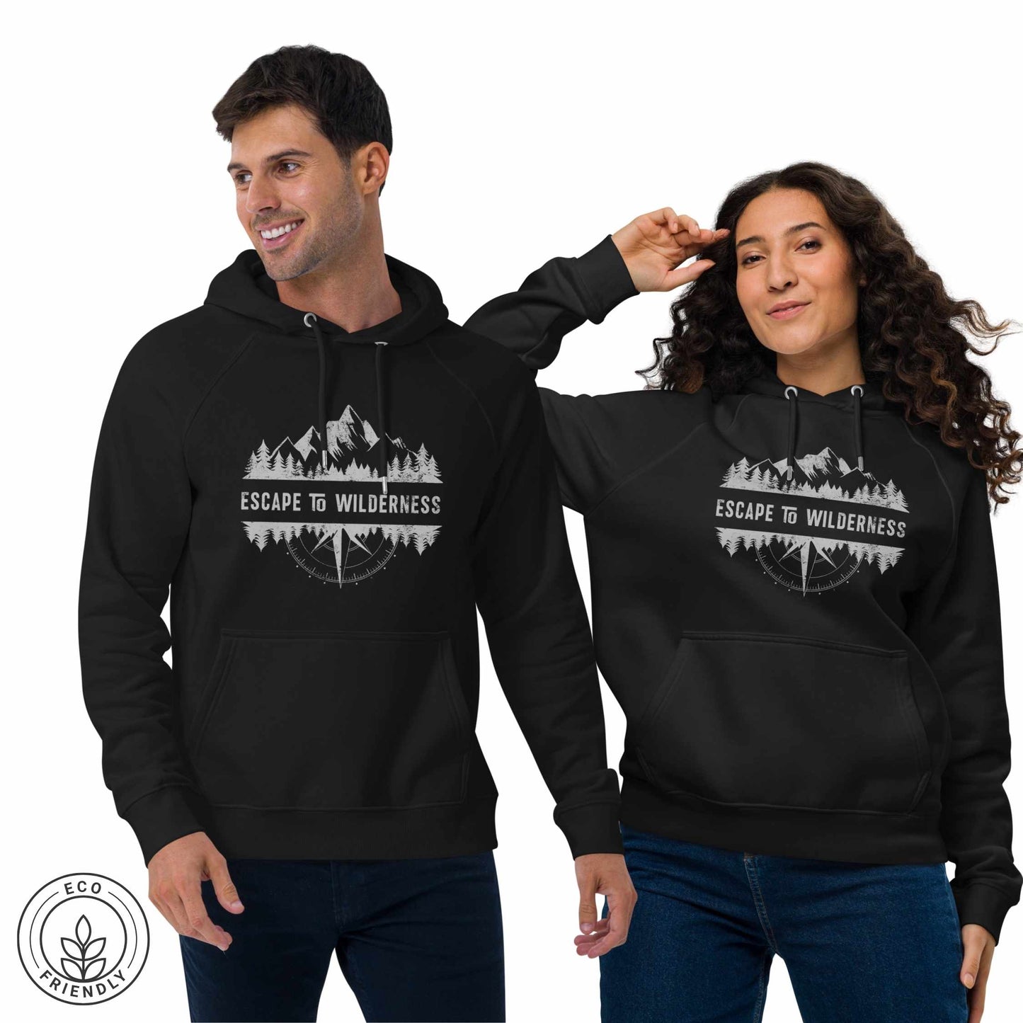 Happy outdoorsy man and woman wearing black hoodies featuring  forest, mountain and compass design and 'Escape to Wilderness' graphic text on a white background