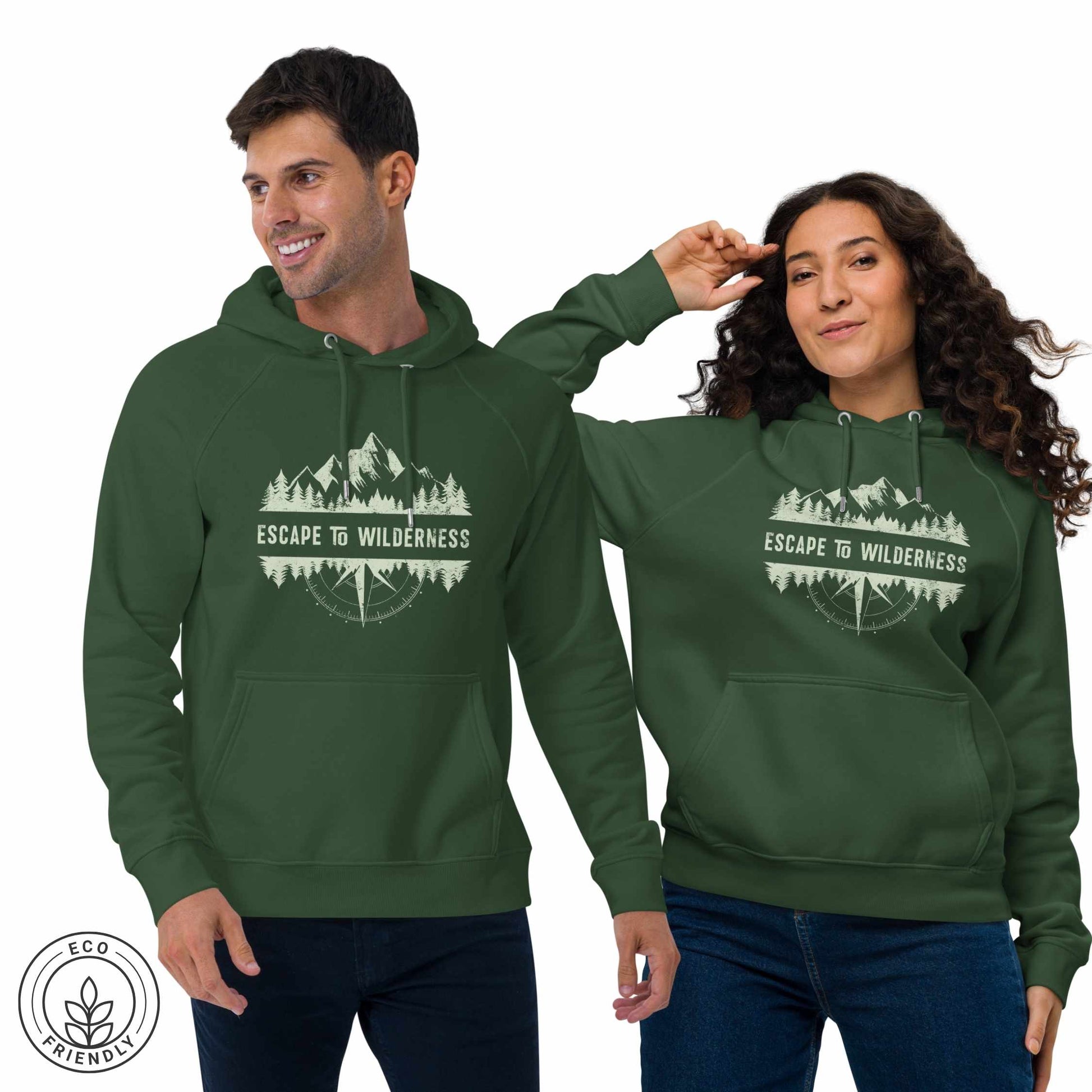 Happy outdoorsy man and woman  wearing green eco-friendly hoodies featuring forest, mountain and compass design and  'Escape to Wilderness' graphic text on a white background