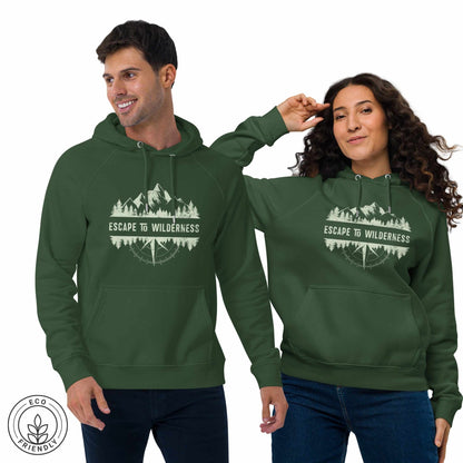 Happy outdoorsy man and woman  wearing green eco-friendly hoodies featuring forest, mountain and compass design and  'Escape to Wilderness' graphic text on a white background