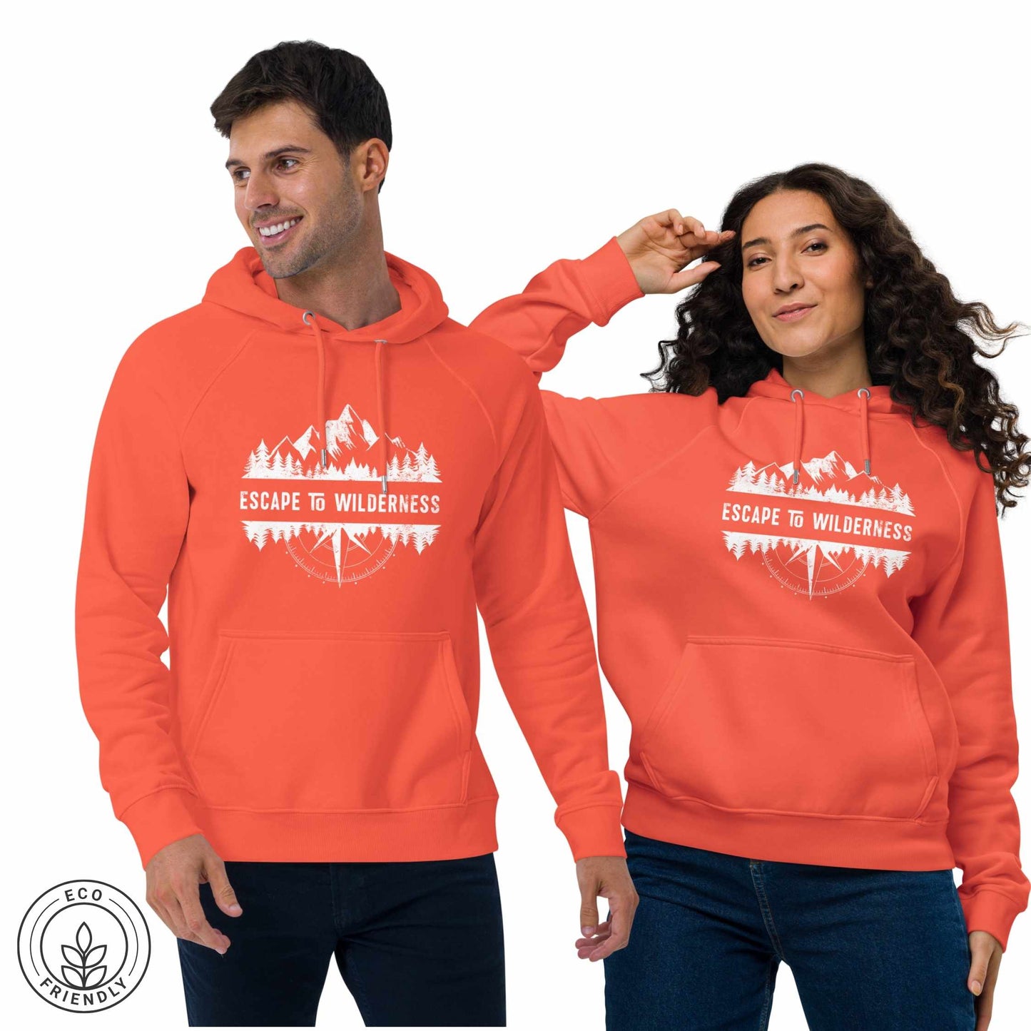 Happy outdoorsy man and woman  wearing orange eco-friendly hoodie featuring forest, mountain and compass design and  'Escape to Wilderness' graphic text on a white background.