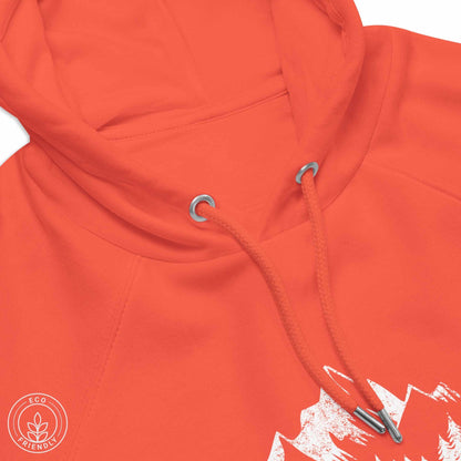 Close-up of an orange Green eco-friendly hoodie featuring forest, mountain and compass design and  'Escape to Wilderness' graphic text