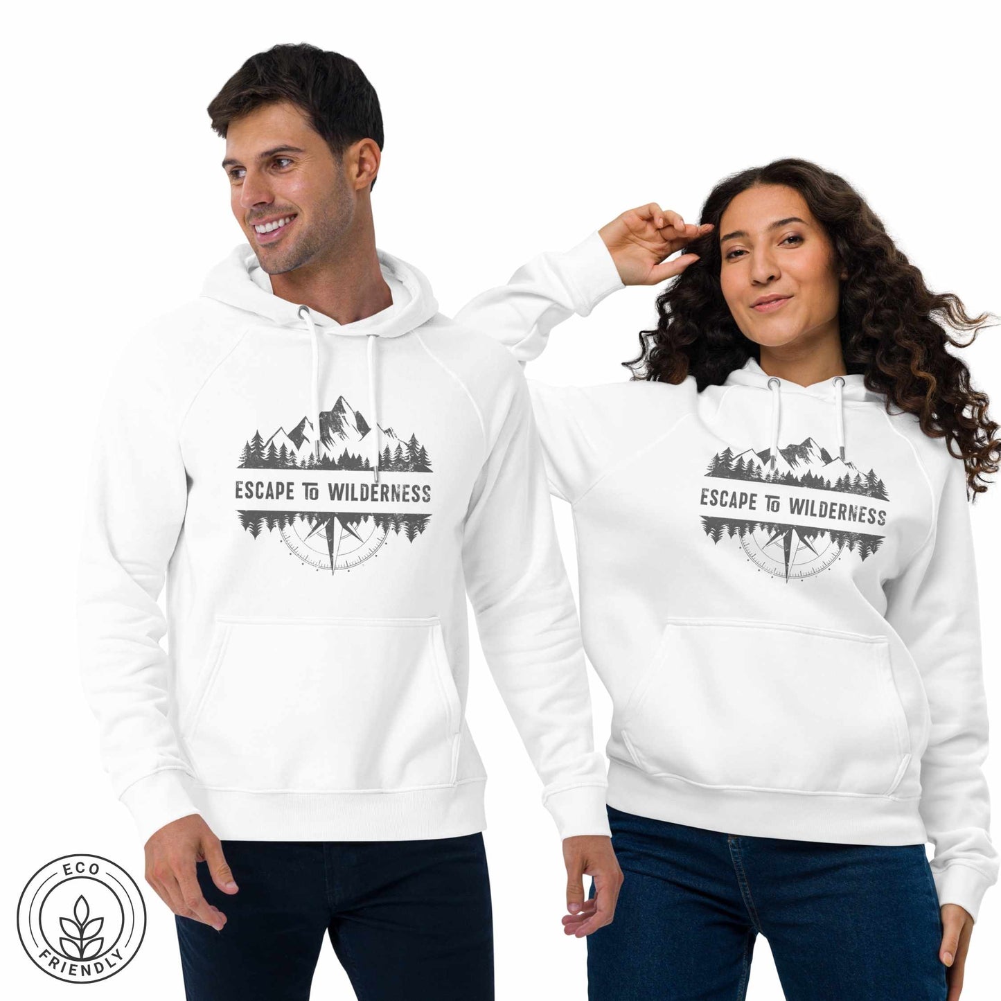 Happy outdoorsy man and woman wearing white eco-friendly hoodie featuring forest, mountain and compass design and  'Escape to Wilderness' graphic text on a white background