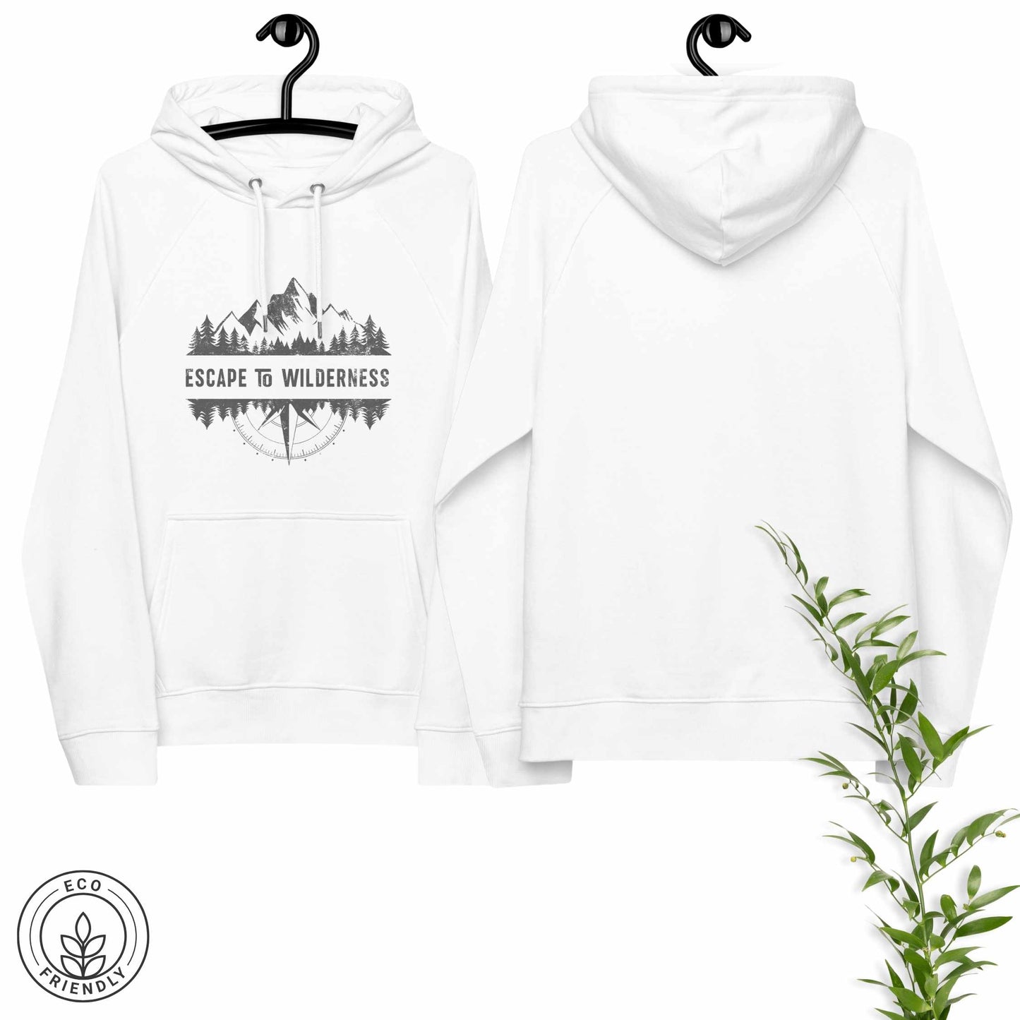 White eco-friendly hoodie featuring forest, mountain and compass design and  'Escape to Wilderness' graphic text on a hanger with greenery.