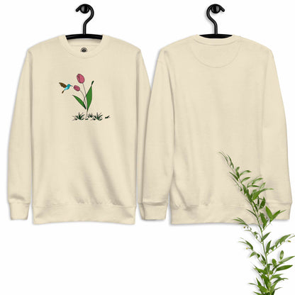 Beige sweatshirt with floral design featuring tulips and hummingbird on a white background