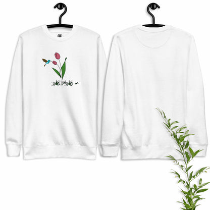 White sweatshirt with floral design featuring tulips and a hummingbird on a hanger against a white background