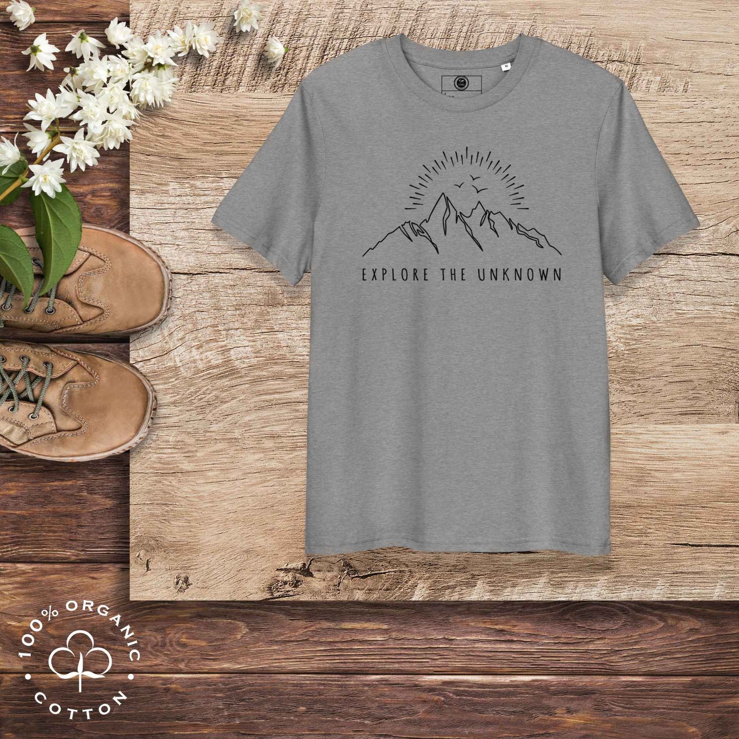 Eco-friendly -shirt with  with mountain design and 'Explore the Unknown' text.