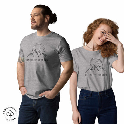 happy man and woman wearing Gray khaki organic cotton t-shirt with mountain, sun and birds graphic and 'Explore the Unknown' text on a white background.