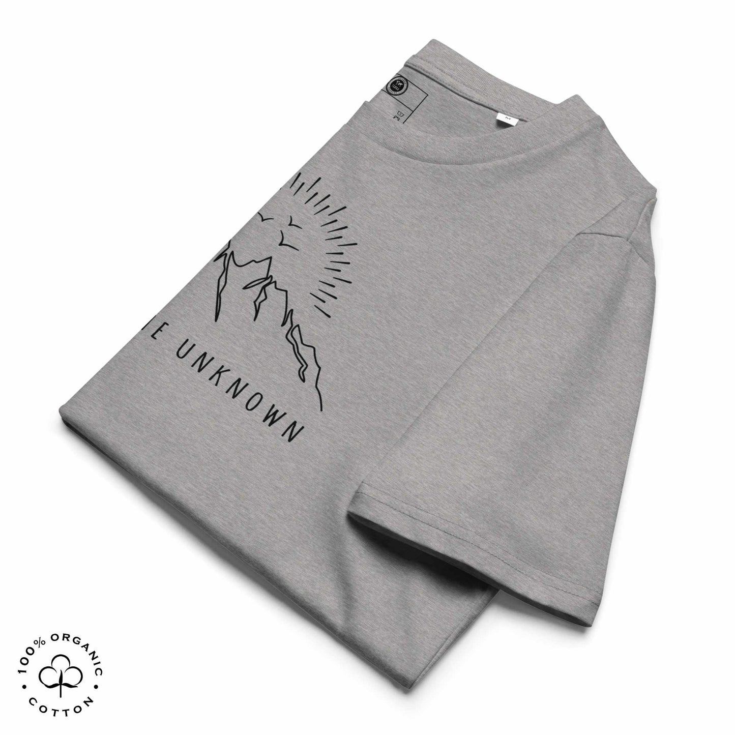 Folded Gray khaki organic cotton t-shirt with mountain, sun and birds graphic and 'Explore the Unknown' text on a white background