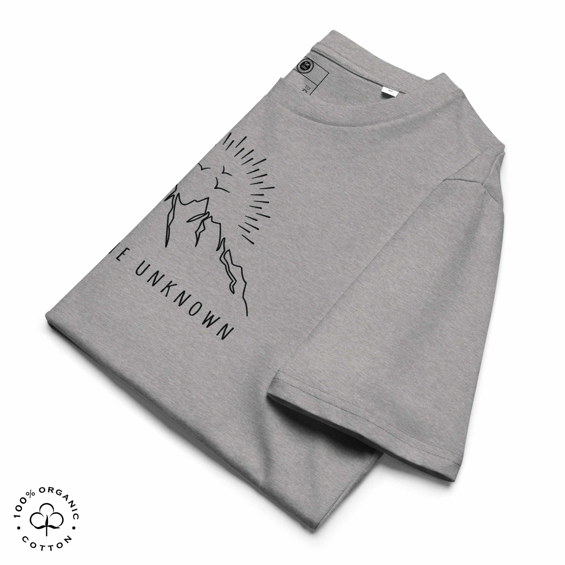Folded Gray khaki organic cotton t-shirt with mountain, sun and birds graphic and 'Explore the Unknown' text on a white background