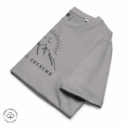 Folded Gray khaki organic cotton t-shirt with mountain, sun and birds graphic and 'Explore the Unknown' text on a white background