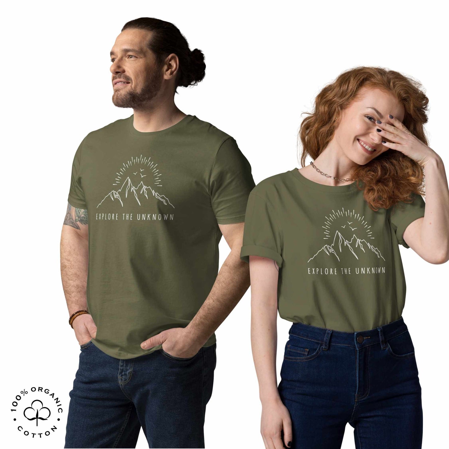 happy man and woman wearing khaki organic cotton t-shirt with mountain, sun and birds graphic and 'Explore the Unknown' text on a white background.