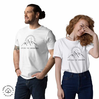 happy Man and woman wearing white organic cotton t-shirt with mountain, sun and birds graphic and 'Explore the Unknown' text on a white background.