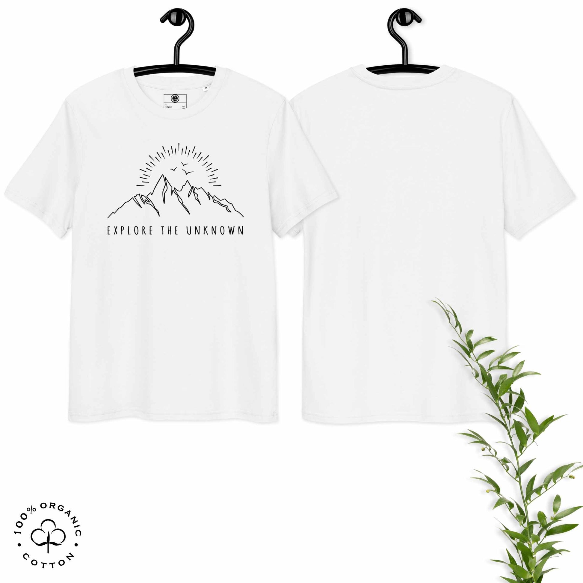 White organic cotton t-shirt with mountain, sun and birds graphic and 'Explore the Unknown' text on hangers, with a plant on a white background.