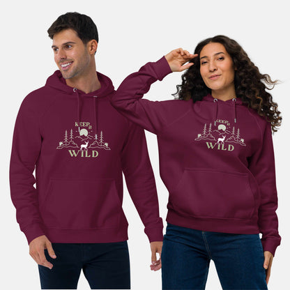 Man and woman wearing burgundy eco hoodie with 'Keep it Wild' bold and deer, mountain, forest graphic design