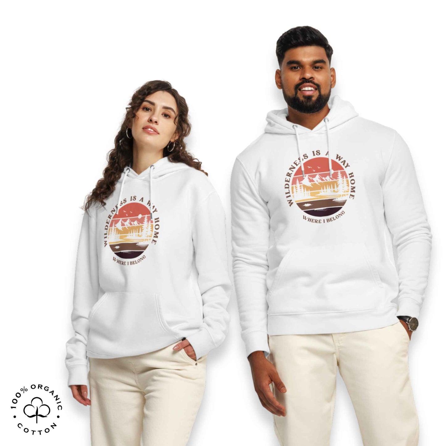 Woman and men wearing white organic cotton hoodie with nature-themed graphic, mountain, forest, sun and river. With bold Wilderness is a way home, where I belong. 