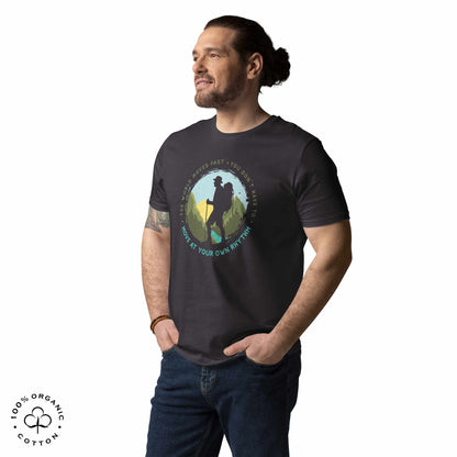 Man wearing grey organic cotton t-shirt with a hiking graphic design and text "Move at your own rhythm" on a white background
