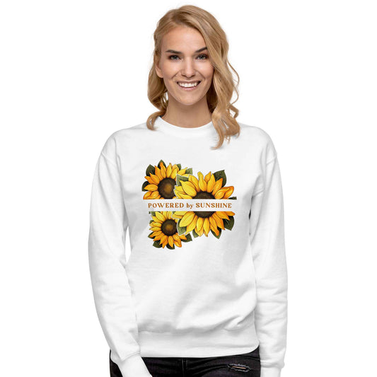 Woman sweatshirt with sunflower design and text Powered by Sunshine.