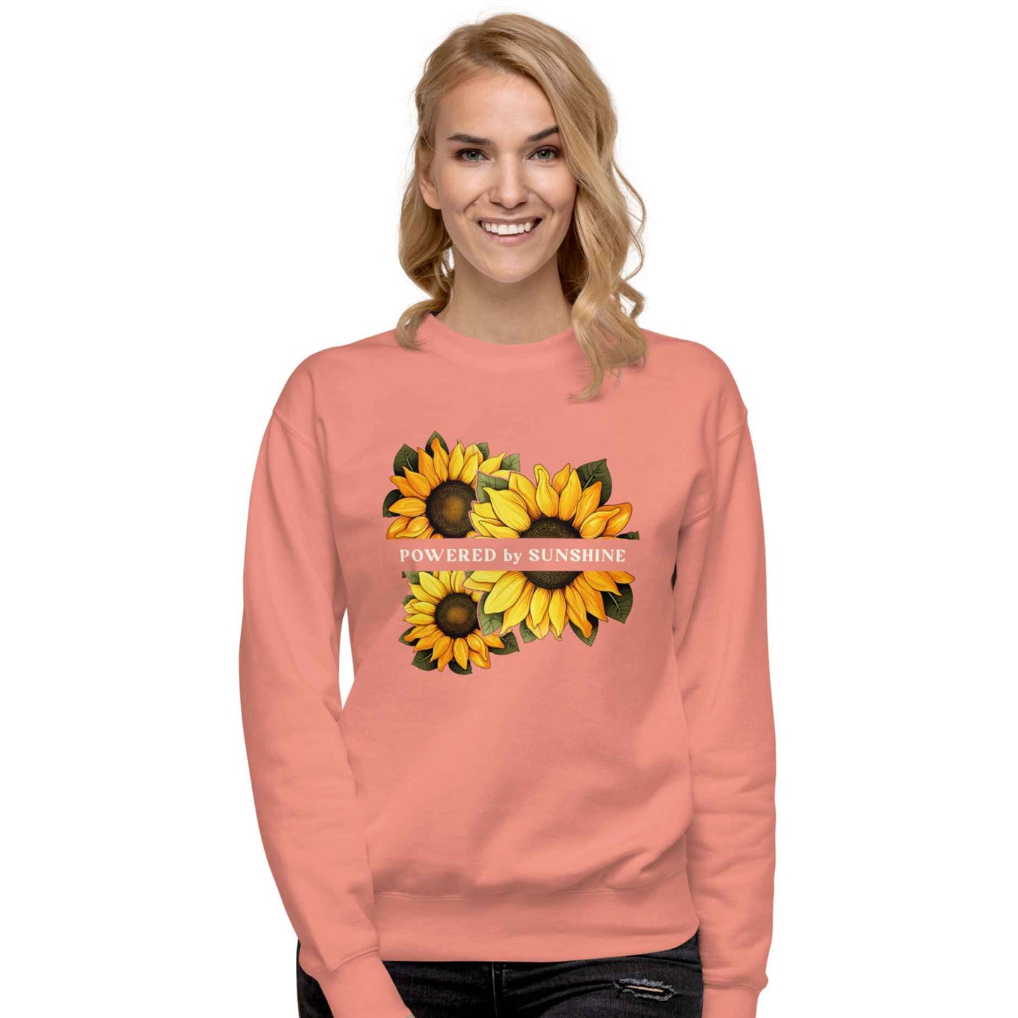 Woman sweatshirt with sunflower design and text Powered by Sunshine.
