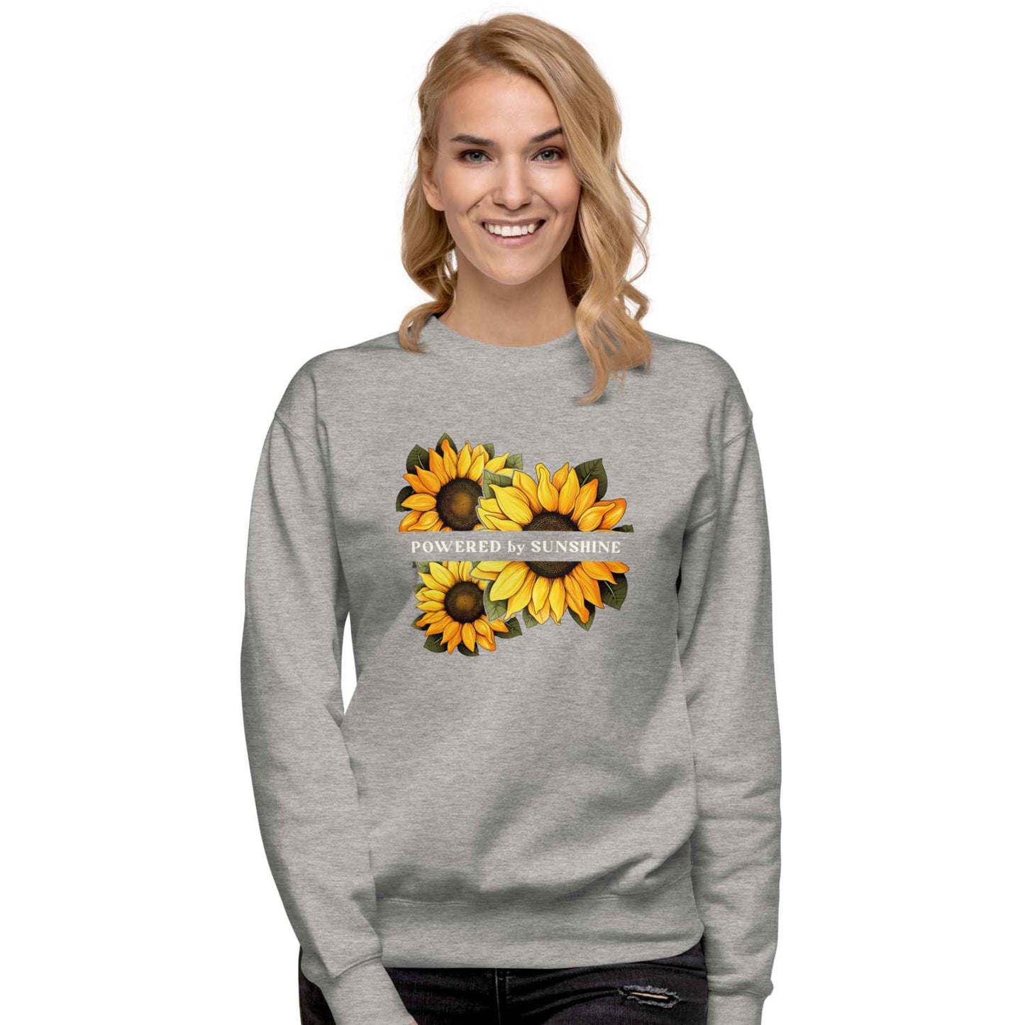 Woman sweatshirt with sunflower design and text Powered by Sunshine.