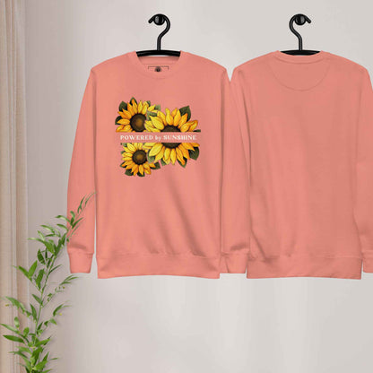 Woman sweatshirt with sunflower design and text Powered by Sunshine.