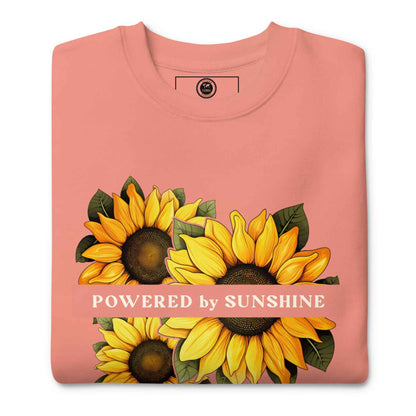 Woman sweatshirt with sunflower design and text Powered by Sunshine.