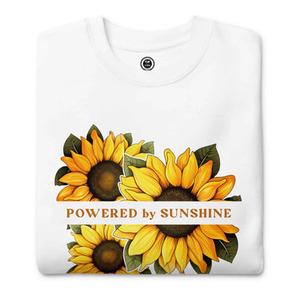 Woman sweatshirt with sunflower design and text Powered by Sunshine.