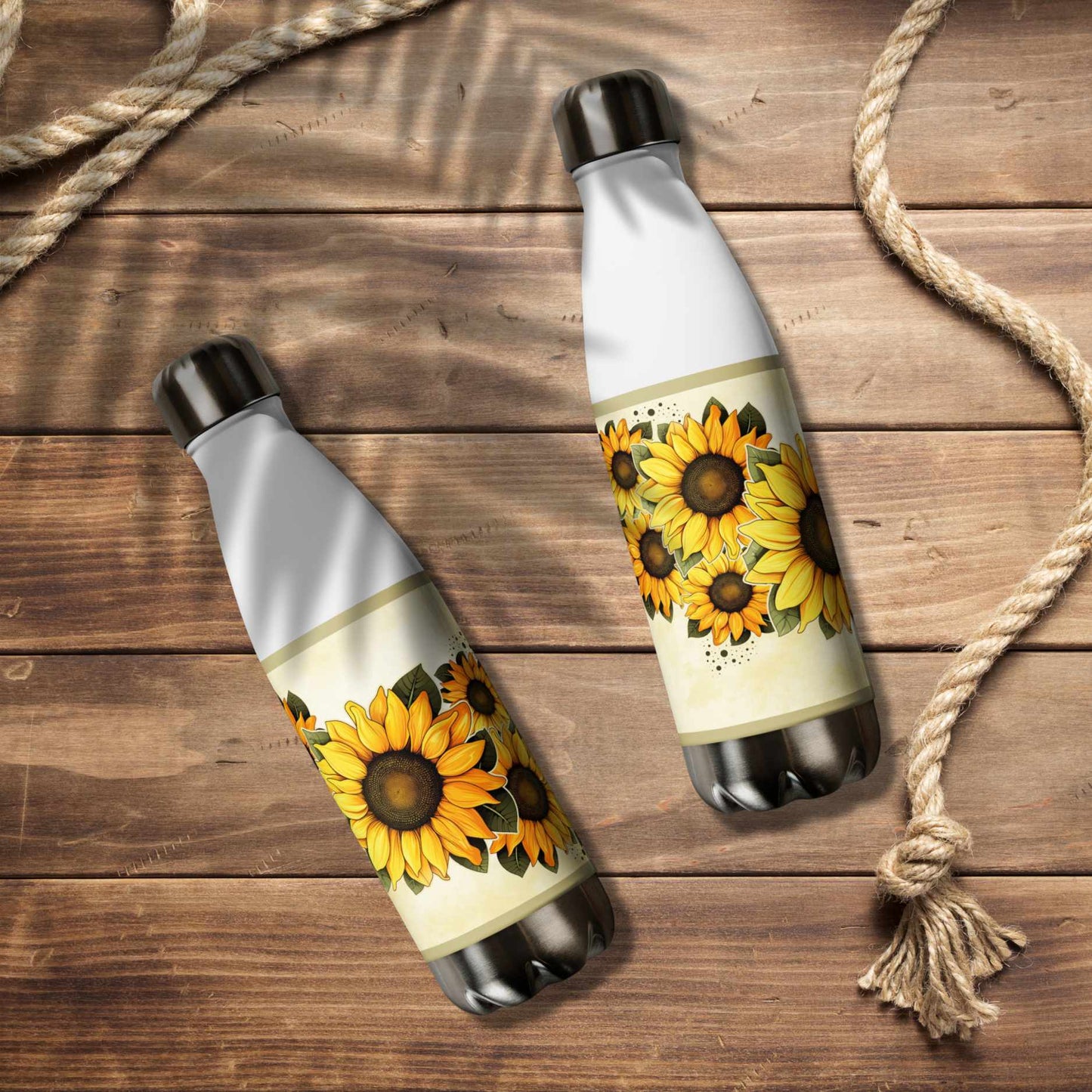 Two water bottle stainless steel with sunflower designs on a wooden surface.