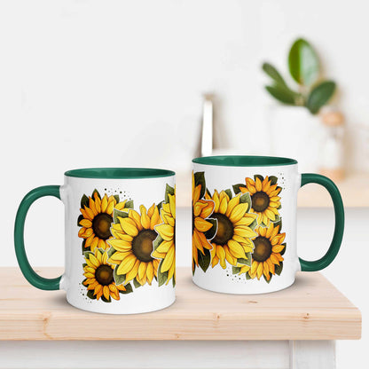White and green ceramic mug 11 oz with green handle and  sunflower design on a wooden surface