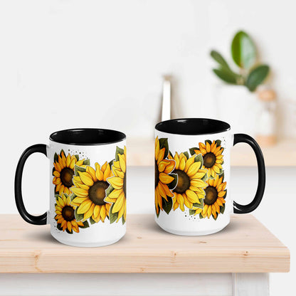 White and black ceramic mug with black handle featuring sunflower design on a wooden surface