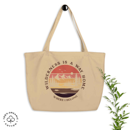 Oyster organic cotton large tote bag with nature-themed design: forest, trees, sun, lake. 'Wilderness is a Way Home, Where I belong' text. 