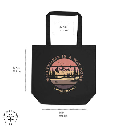 Black organic cotton medium tote bag with nature-themed design: forest, trees, sun, lake. 'Wilderness is a Way Home, Where I belong' text. 