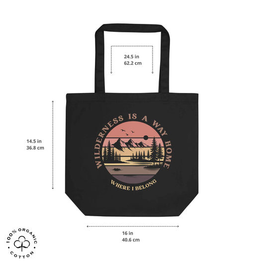 Black organic cotton medium tote bag with nature-themed design: forest, trees, sun, lake. 'Wilderness is a Way Home, Where I belong' text. 