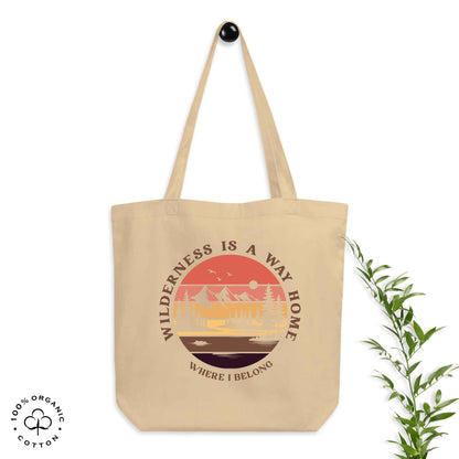 Oyster organic cotton medium tote bag with nature-themed design: forest, trees, sun, lake. 'Wilderness is a Way Home, Where I belong' text. 