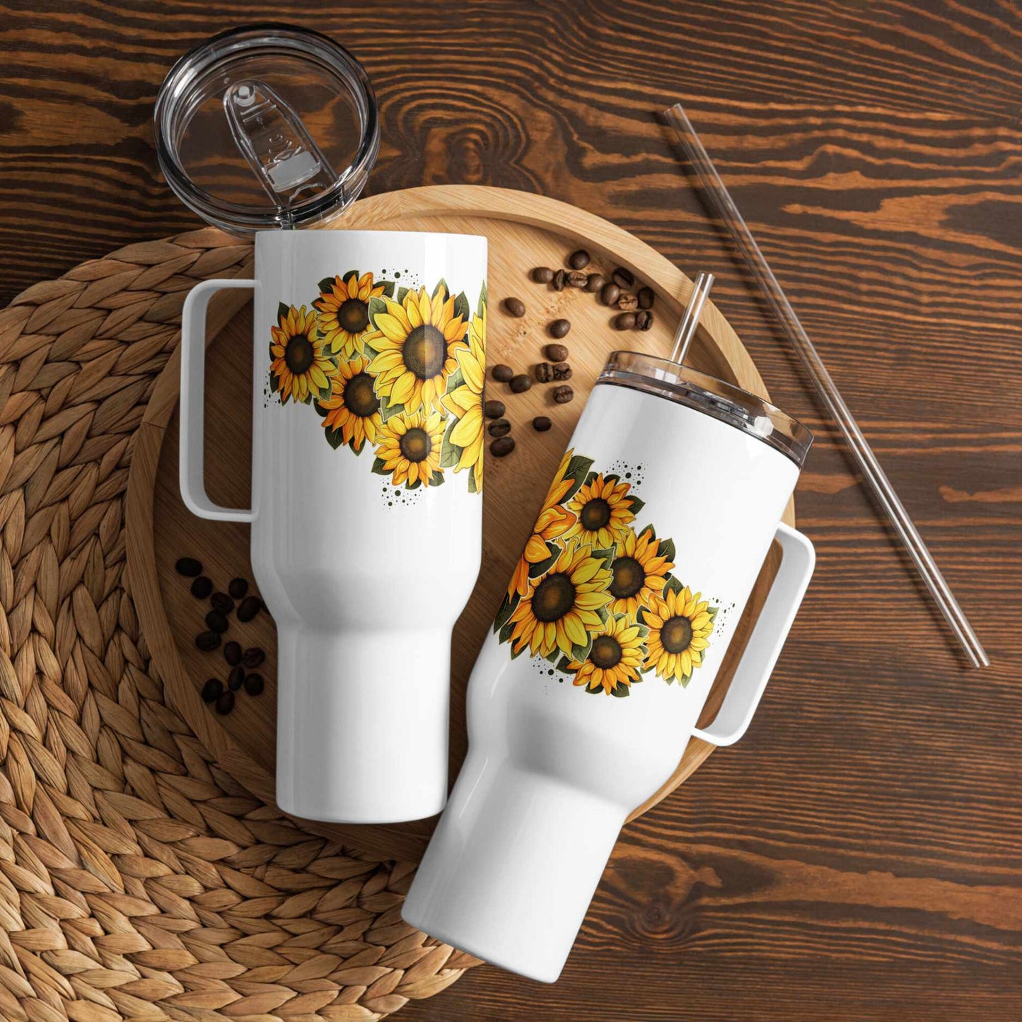 Two white tumblers insulated travel mug 40 oz with sunflower designs on a wooden surface with coffee beans and straws.