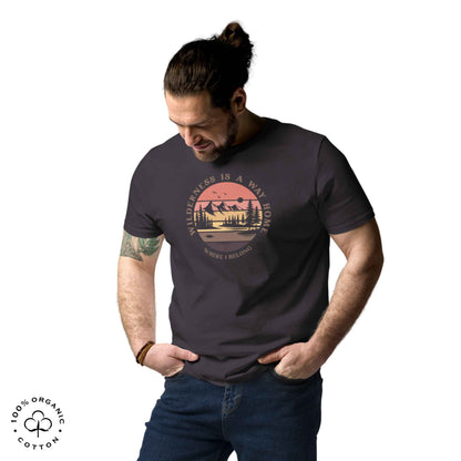 Men wearing eco-friendly t-shirt in organic cotton, anthracite grey with graphic featuring a nature theme: mountains, trees, sun and the bold phrase “wild nature is the way home, where I belong”.