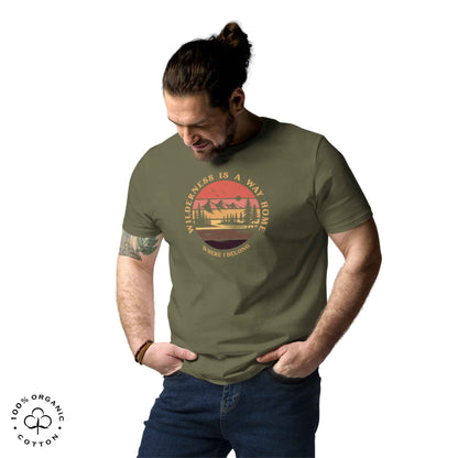 Man wearing eco-friendly t-shirt in organic cotton, khaki, with graphic featuring a nature theme: mountains, trees, sun and the bold phrase “wild nature is the way home, where I belong”.
