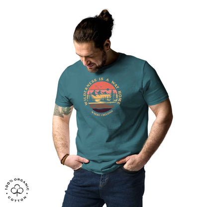 Man wearing eco-friendly t-shirt in organic cotton, stargazer, with graphic featuring a nature theme: mountains, trees, sun and the bold phrase “wild nature is the way home, where I belong”.